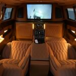 Elegant limousine interior featuring plush leather seats and ambient lighting for ultimate comfort.