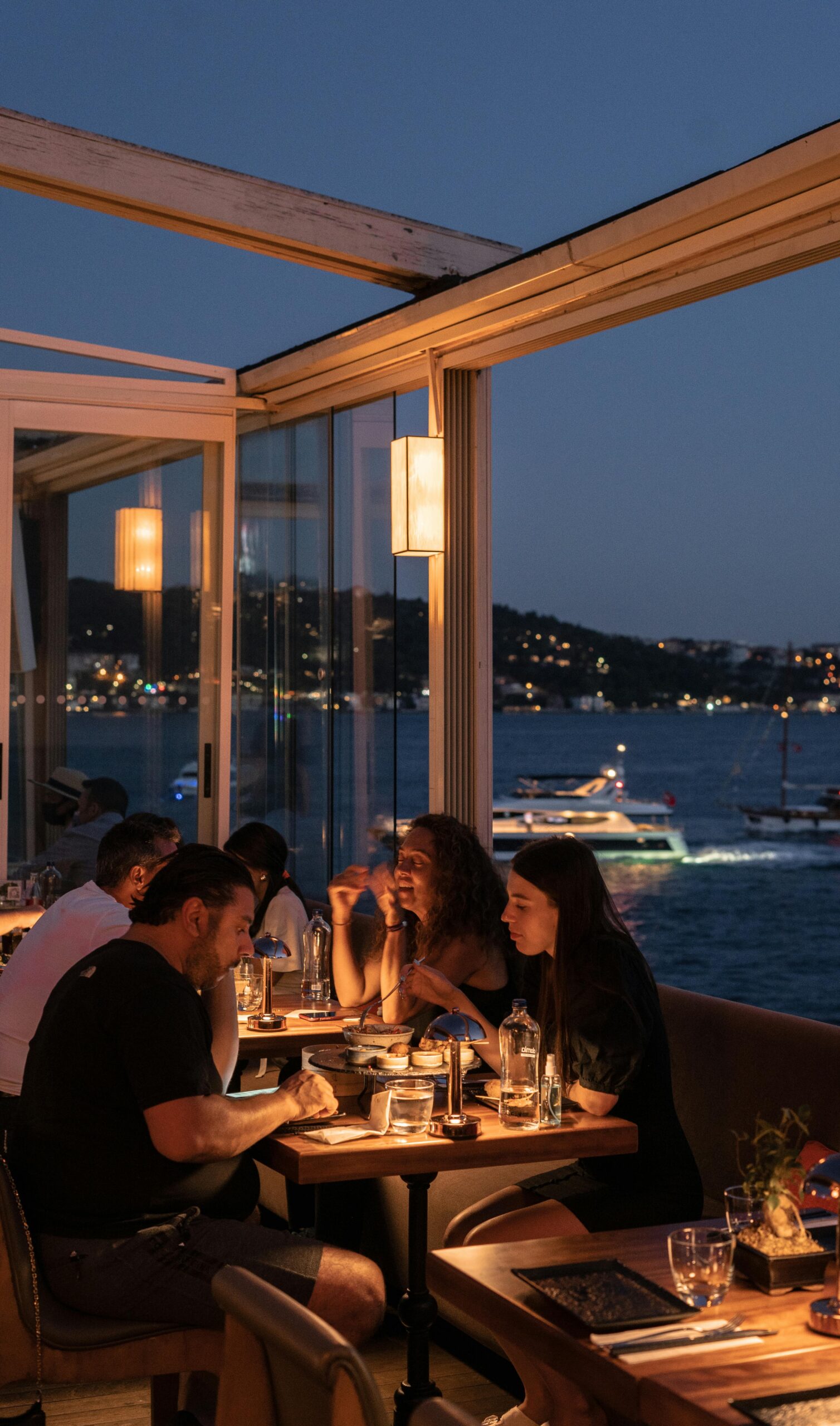 Group enjoying dinner with a scenic Bosphorus view in Istanbul.